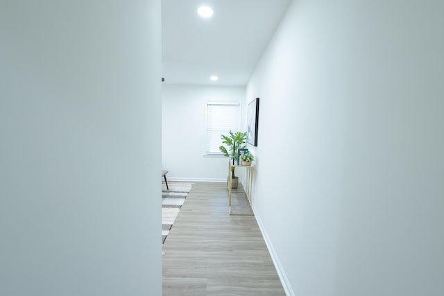 corridor featuring recessed lighting, baseboards, and light wood-style flooring