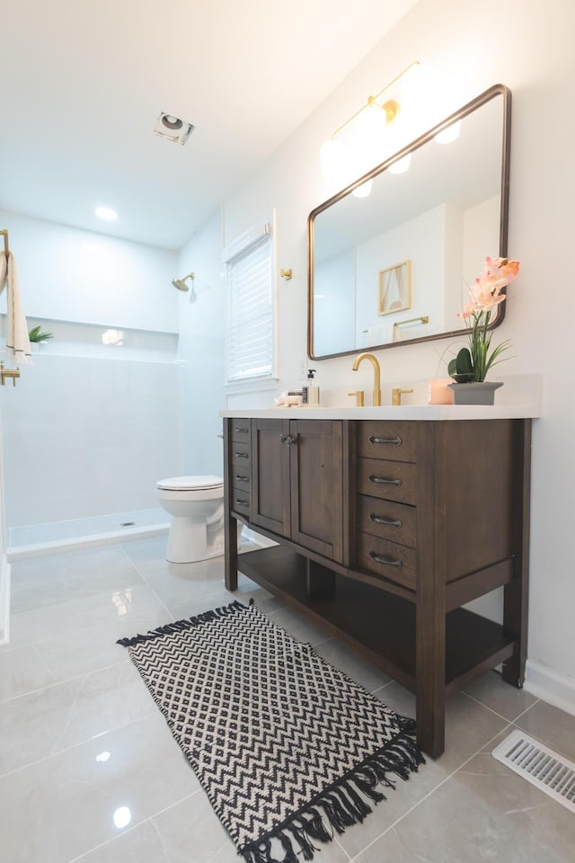 full bath featuring walk in shower, toilet, vanity, and tile patterned floors