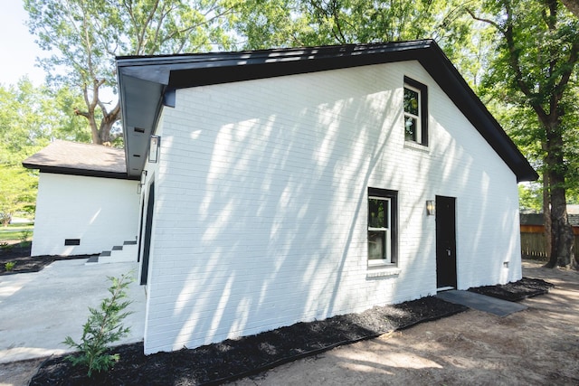 view of property exterior featuring brick siding