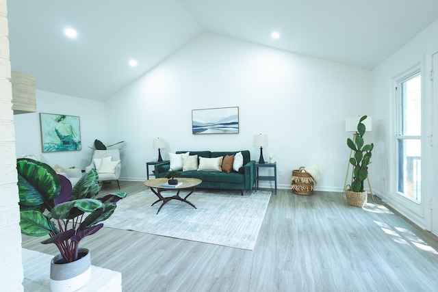 living room featuring lofted ceiling, wood finished floors, baseboards, and recessed lighting
