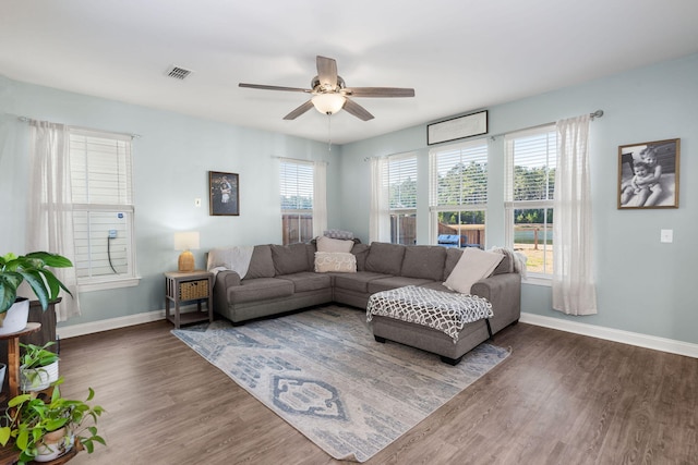 living room with ceiling fan and dark wood-type flooring