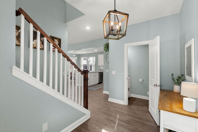 foyer entrance with dark wood-type flooring and a chandelier