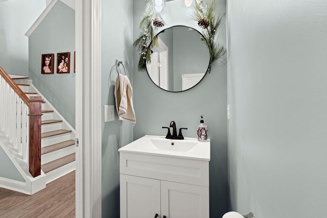 bathroom with hardwood / wood-style flooring and vanity