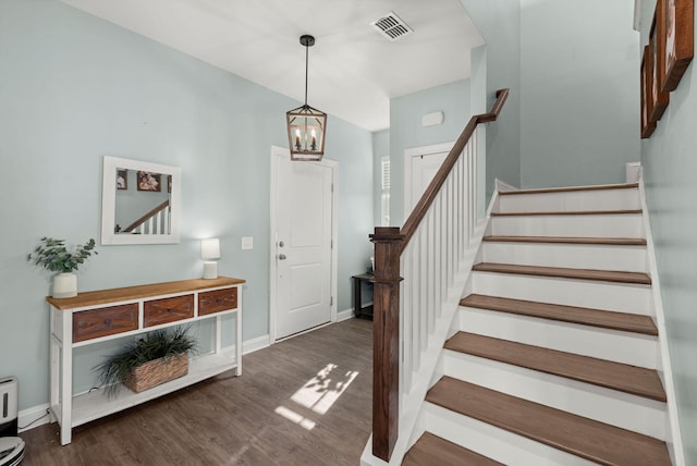 foyer featuring dark hardwood / wood-style flooring and a notable chandelier