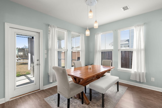 dining area featuring a wealth of natural light and hardwood / wood-style flooring