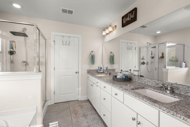 bathroom with vanity, tile patterned floors, and walk in shower