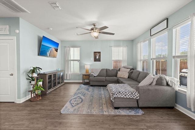 living room with dark wood-type flooring and ceiling fan