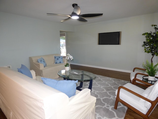 living room with dark hardwood / wood-style floors and ceiling fan