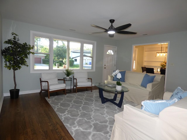 living room with dark hardwood / wood-style floors and ceiling fan