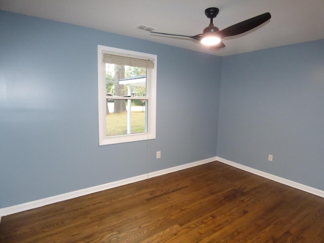 unfurnished room with ceiling fan and dark wood-type flooring