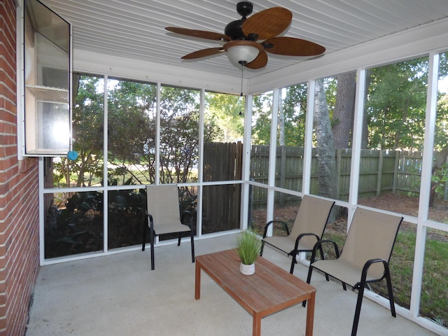 unfurnished sunroom featuring ceiling fan and a healthy amount of sunlight