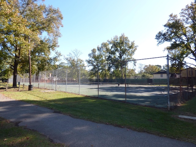 view of sport court featuring a lawn