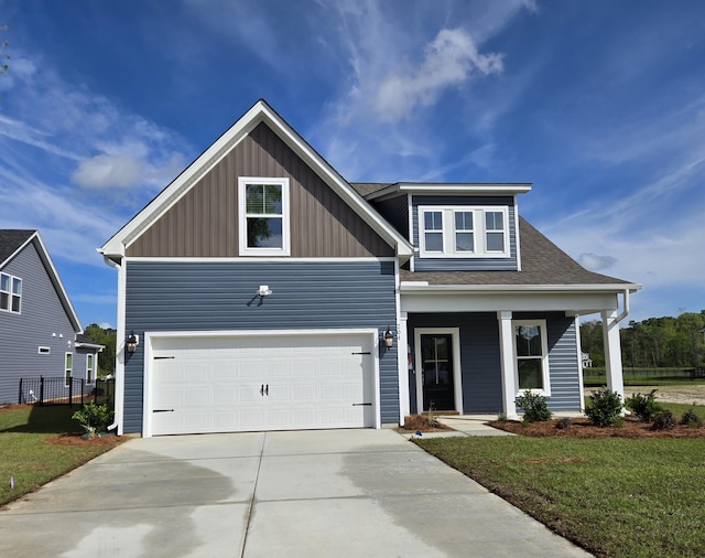 view of front of property with concrete driveway, board and batten siding, covered porch, an attached garage, and a front yard