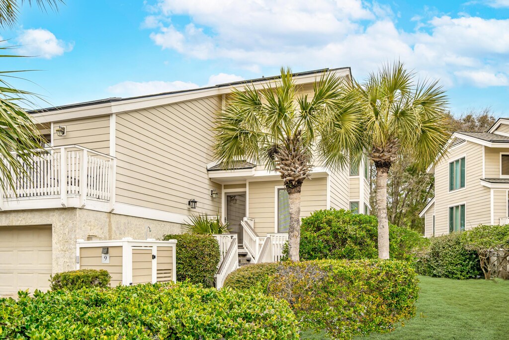 9 Fairway Dunes Ln, Isle Of Palms, SC 29451 - multi unit property with a front lawn, a balcony, and an attached garage