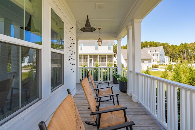 balcony featuring covered porch and ceiling fan