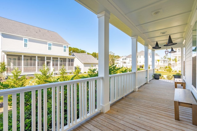 wooden deck featuring a sunroom, a porch, and ceiling fan