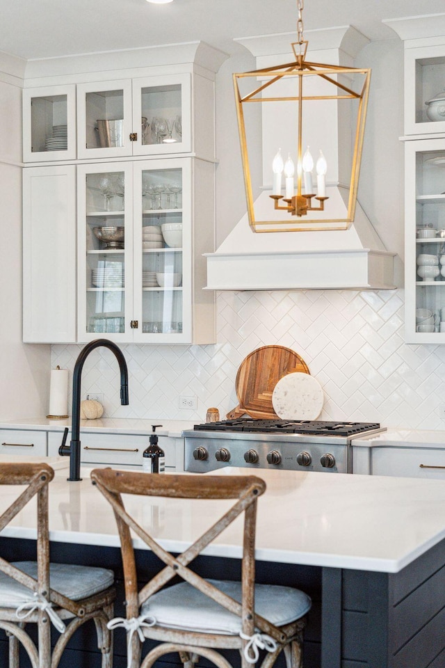 kitchen featuring a breakfast bar, white cabinetry, and hanging light fixtures