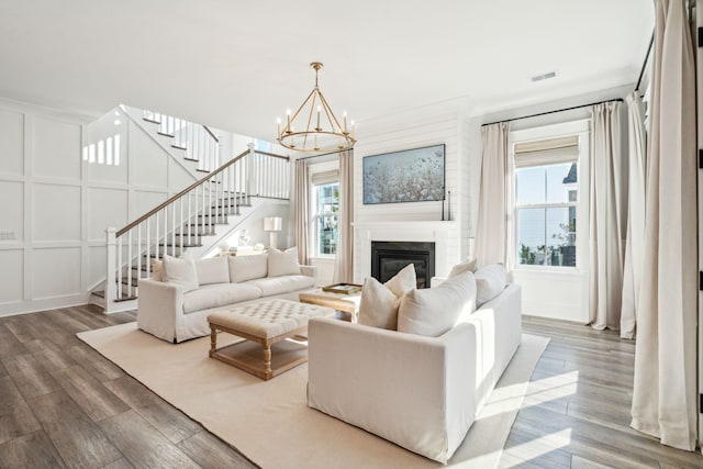 living room with an inviting chandelier and wood-type flooring