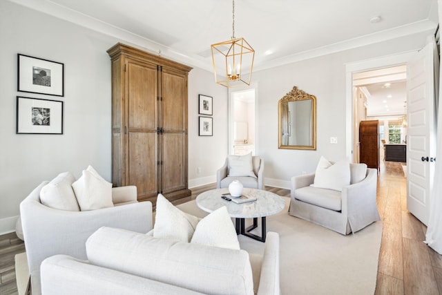 living room with ornamental molding, light hardwood / wood-style flooring, and an inviting chandelier