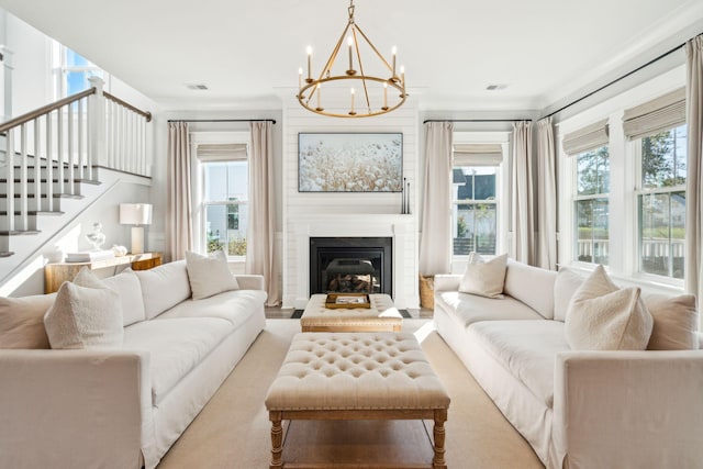 living room featuring an inviting chandelier and a fireplace