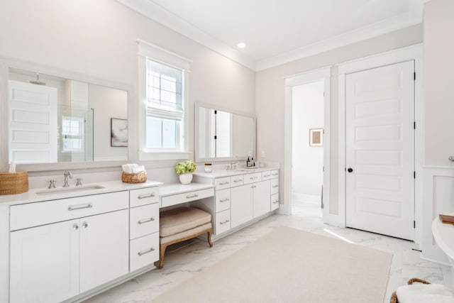 bathroom featuring vanity, crown molding, and a shower with door