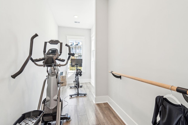 workout room with hardwood / wood-style flooring