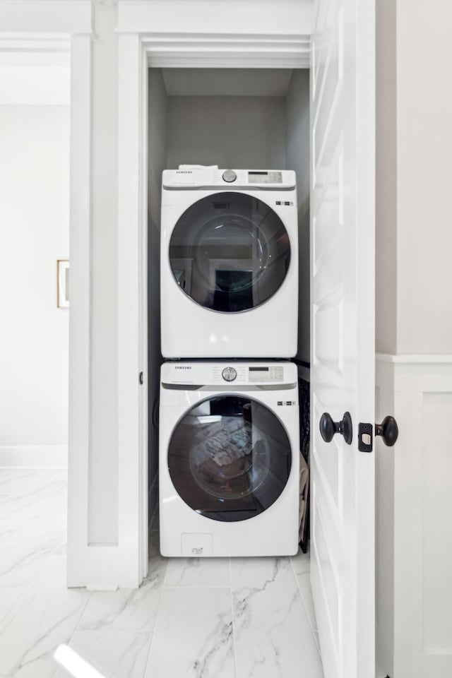 laundry area featuring stacked washer / drying machine