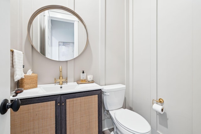 bathroom featuring toilet and vanity