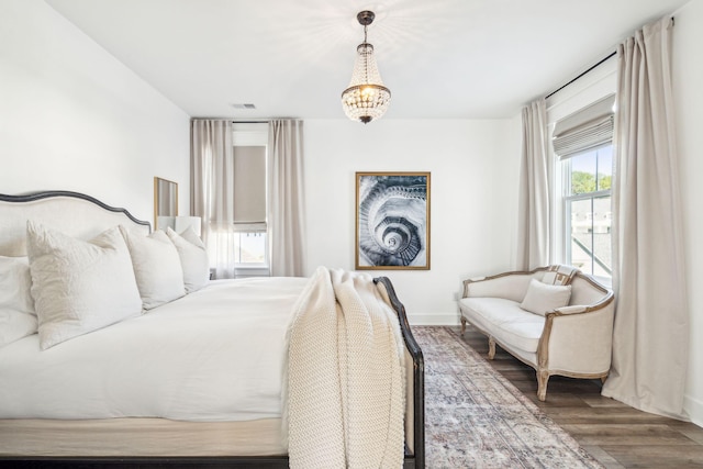 bedroom featuring a notable chandelier and hardwood / wood-style floors