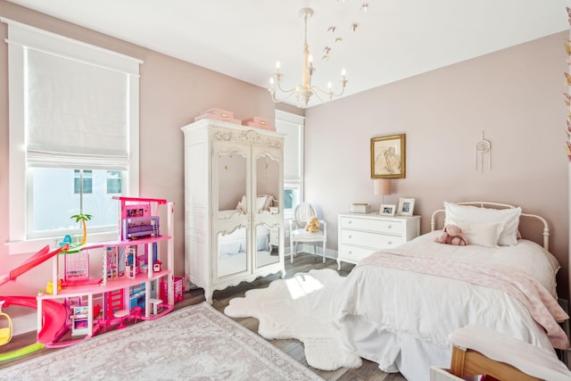 bedroom with a chandelier and wood-type flooring