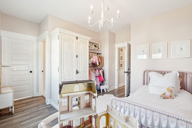 bedroom with a notable chandelier and wood-type flooring