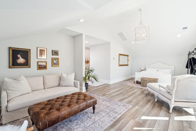 living room with a chandelier, vaulted ceiling, and light wood-type flooring