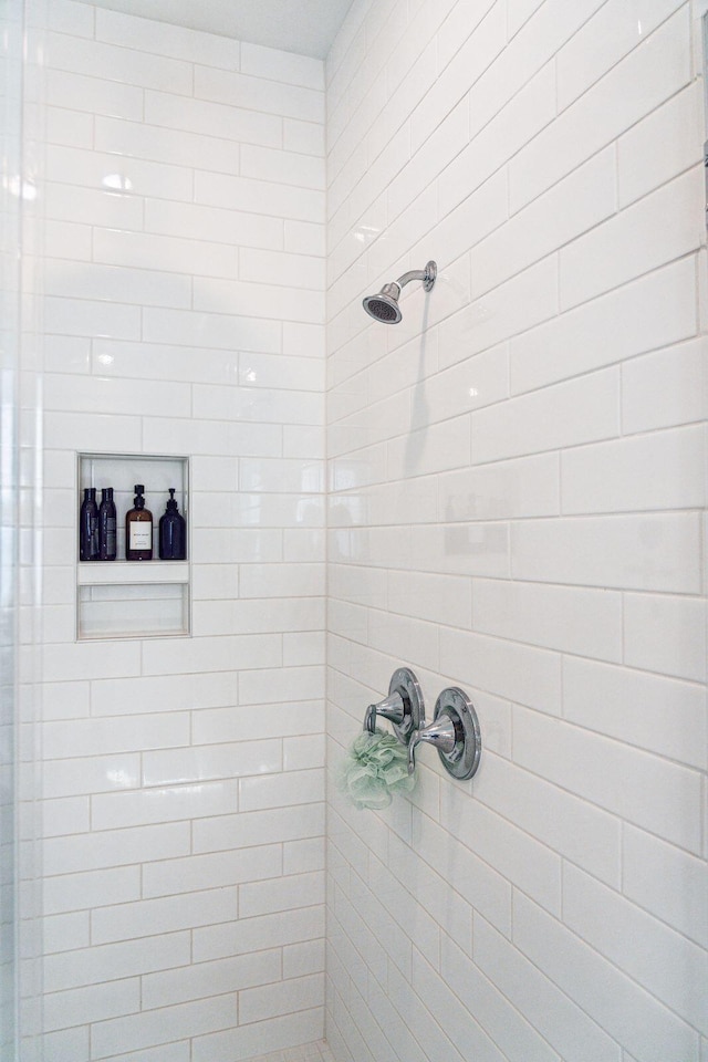 bathroom with a tile shower