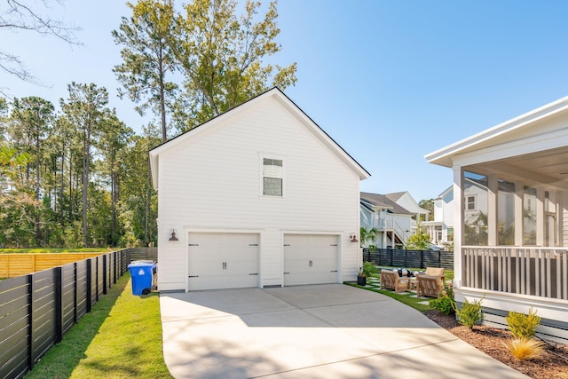 view of side of home featuring a garage and a sunroom