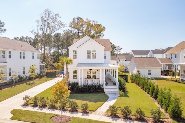 view of front of home featuring covered porch and a front yard