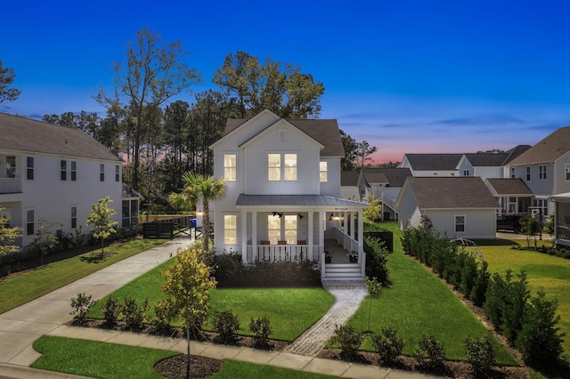 view of front of home featuring a porch and a lawn