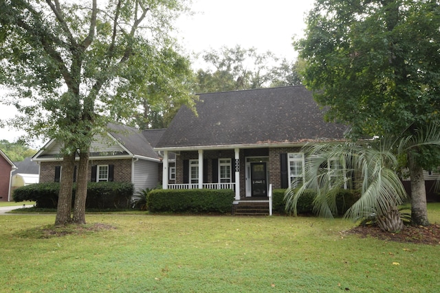 cape cod home featuring covered porch and a front yard