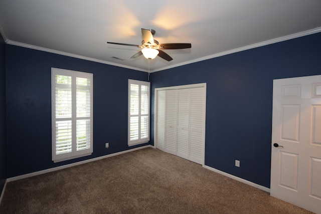 unfurnished bedroom featuring carpet flooring, a closet, ceiling fan, and ornamental molding