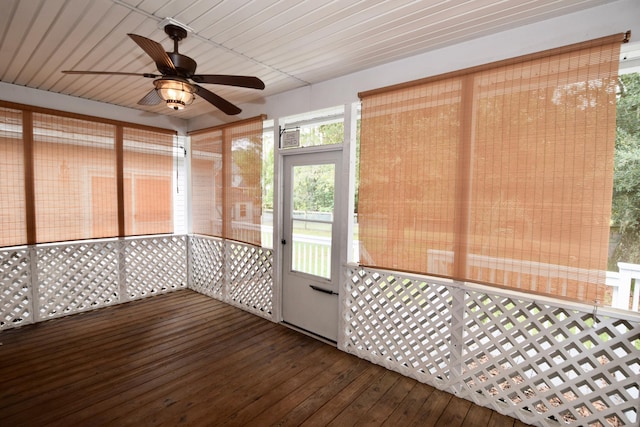 unfurnished sunroom with ceiling fan