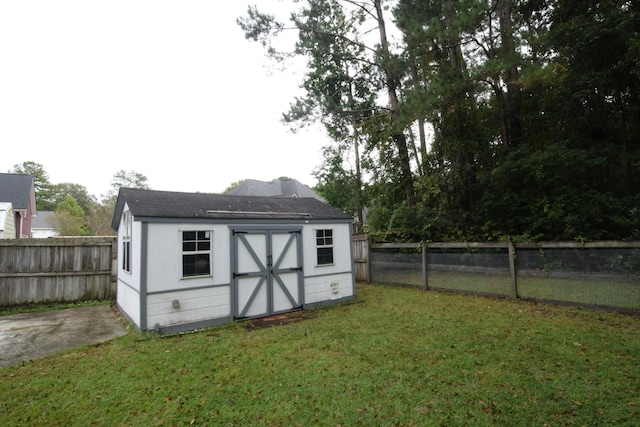 view of outbuilding featuring a lawn