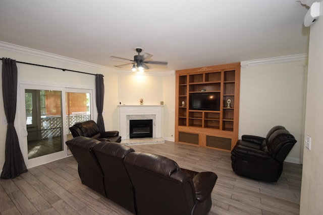 living room with ceiling fan, crown molding, and light hardwood / wood-style flooring