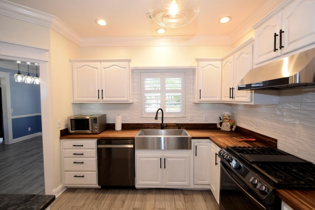 kitchen with black appliances, wooden counters, white cabinetry, and sink