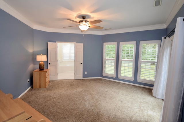 empty room with ceiling fan, ornamental molding, and carpet floors