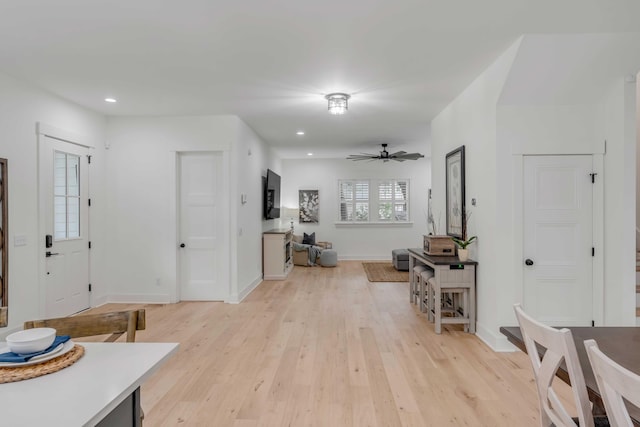 entryway with light hardwood / wood-style floors and ceiling fan