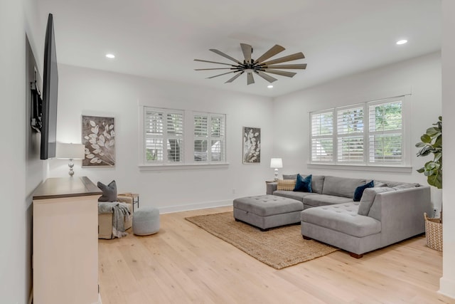 living room featuring ceiling fan and light wood-type flooring