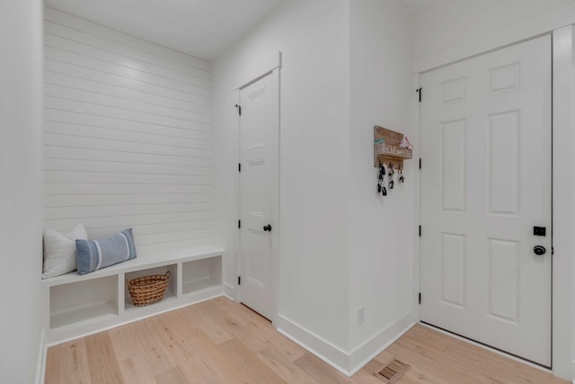 mudroom with light hardwood / wood-style flooring