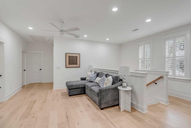 living room featuring ceiling fan, a healthy amount of sunlight, and light wood-type flooring