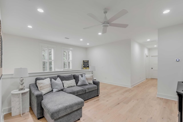 living room with light hardwood / wood-style floors and ceiling fan