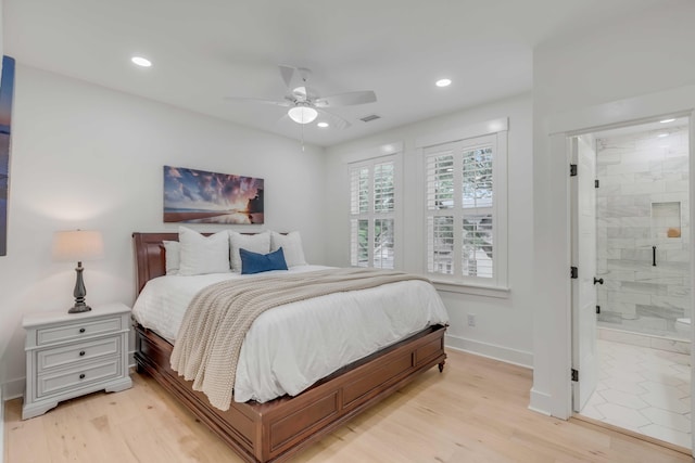 bedroom featuring ceiling fan, ensuite bathroom, and light hardwood / wood-style floors