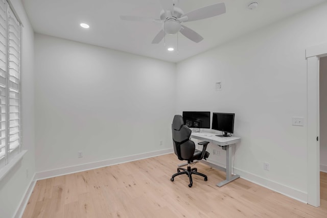 office with ceiling fan and light wood-type flooring